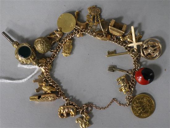 A 9ct gold chain-link charm bracelet set with various 9ct gold charms, a half sovereign, a fob seal watch key, etc.